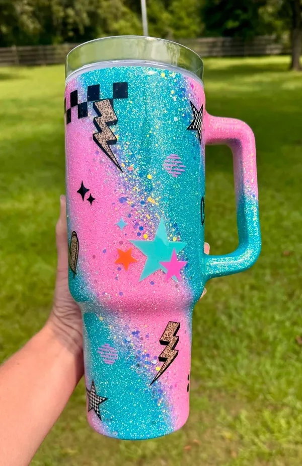 Pink and aqua glitter handle tumbler with stars and lightning bolts